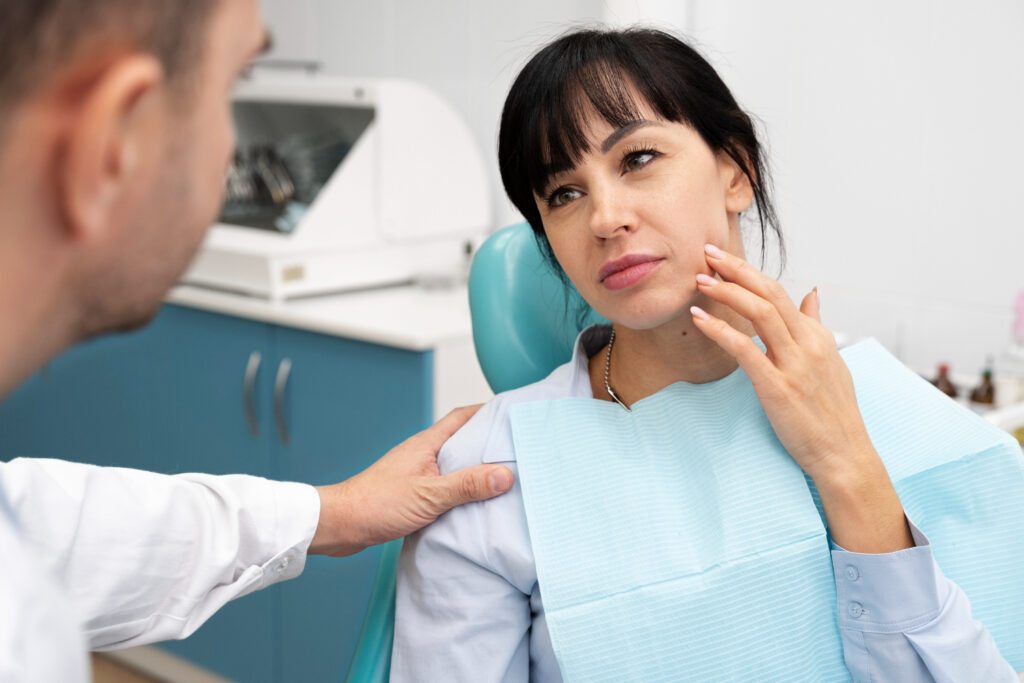 mid adult woman in a dental clinic suffering from wisdom tooth pain