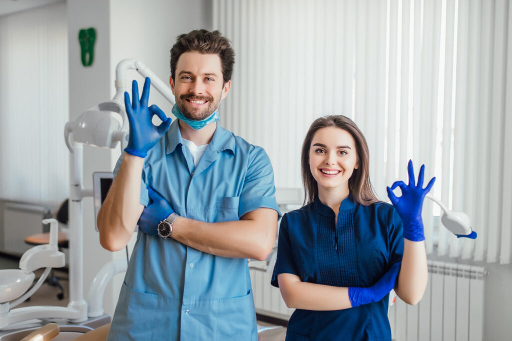 smiling dentist standing answering all the questions to ask an orthodontist